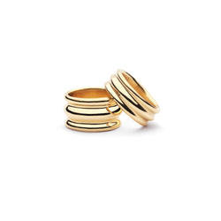 Two gold rings, one resting on the other. on a white background.